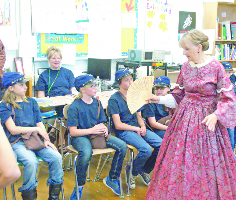 Re-enactor Pam Bowen from Ellington, in the role of a Southern plantation owner’s wife, defends the South’s practice of slavery against the questions and arguments of a group of Yankee soldiers.
