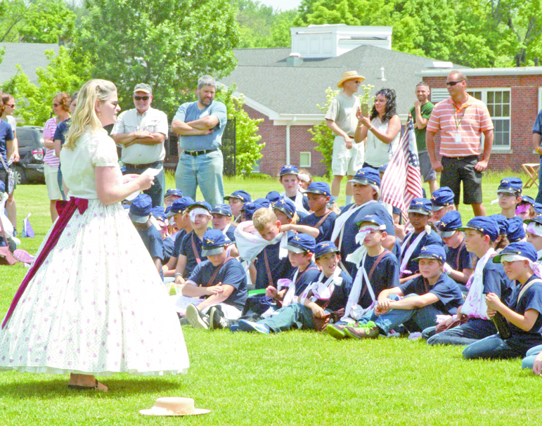 Near the end of McAlister’s Civil War Day, Board of Education chair  Jeanne Gee, garbed in a period outfit, speaks to the assembled soldiers. She closed with an ingenious rewording of Lincoln’s famous Gettysburg Address, hoping that “. . . the lessons of history shall not die in vain.”