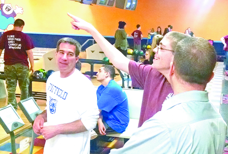 James Mark points happily to the score board during the Suffield High School’s Unified Bowling party on May 19. That’s Athletic Director Michael Bosworth at the left and Principal Steve Moccio in the right foreground.