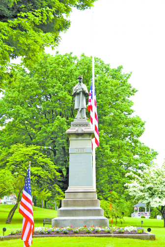 The flag at Suffield’s Soldier’s Monument rests at half mast on Memorial Day.