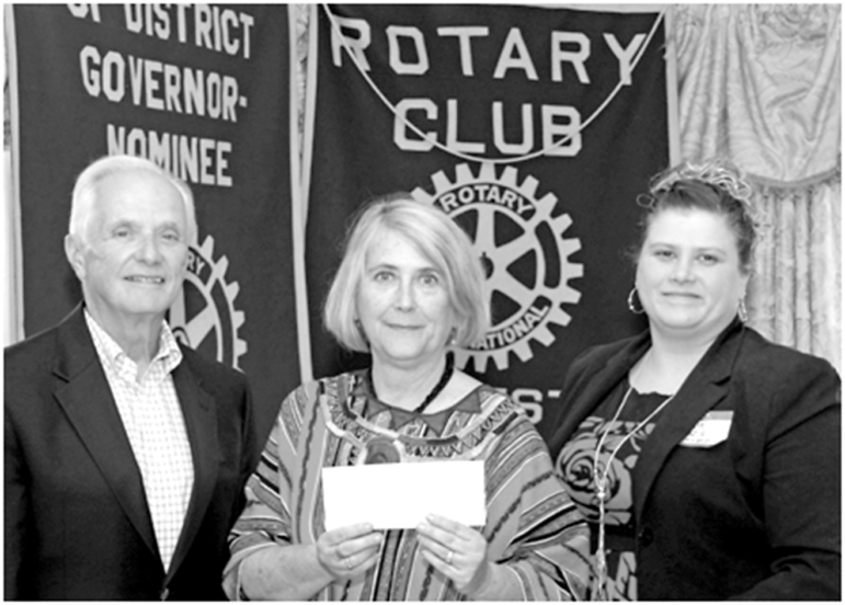 Representing ALDEA. which manages charity for Guatemala, Zoe Kopp shows the donation check she has received from the local Rotary Club District for water and sanitation projects there. Pictured with her, left and right, are Suffield Rotary Vice President Richard Kisiel and President Jackie Guzzi.