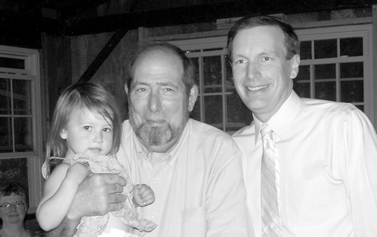 John Smith is pictured with his grand-daughter Charlotte Smith, 3, at the picnic honoring him for his service to Suffield. Senator Chris Murphy is at the right.