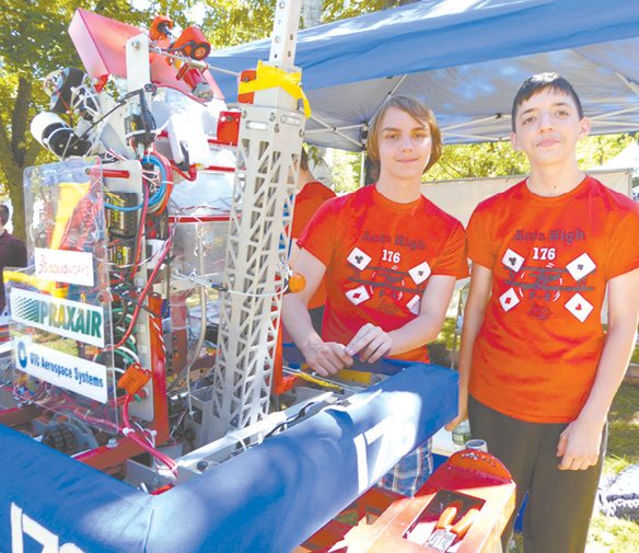 Eddie Gaugin of Suffield High (left) and Dominic Leonard of Windsor Locks High proudly display their Aces High robot.