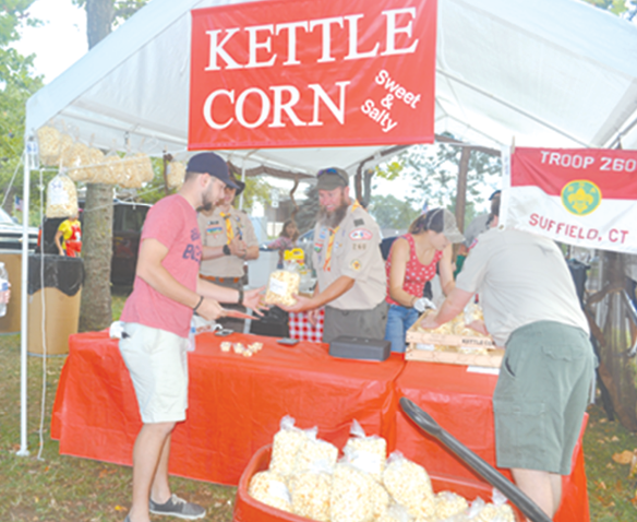 Assistant Scoutmaster Chris Sikes hands over another order of Troop 260’s kettle corn.