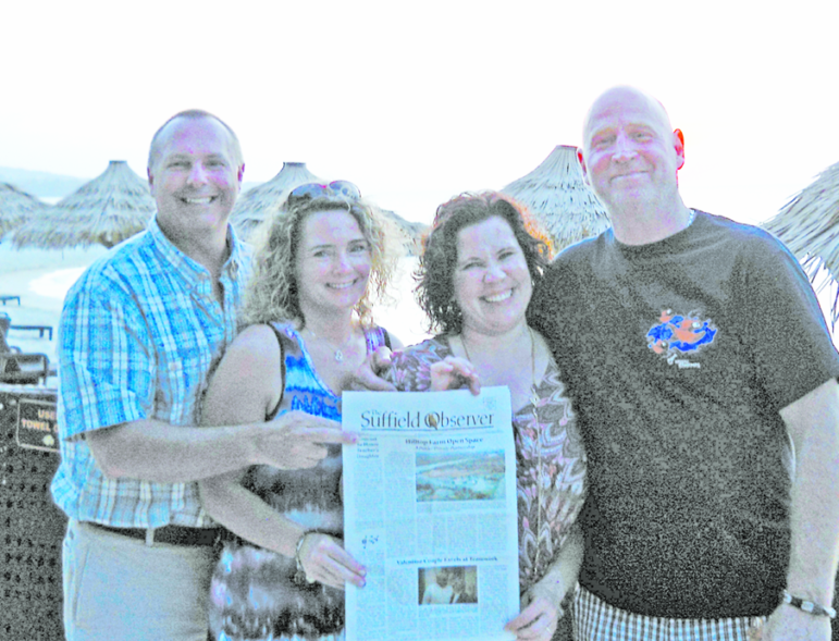 Kevin and Diane Seger and Erin and Mike Ulitsch interrupt their relaxation among the thatched beach umbrellas at Montego Bay, Jamaica, for their portrait with The Suffield Observer.  