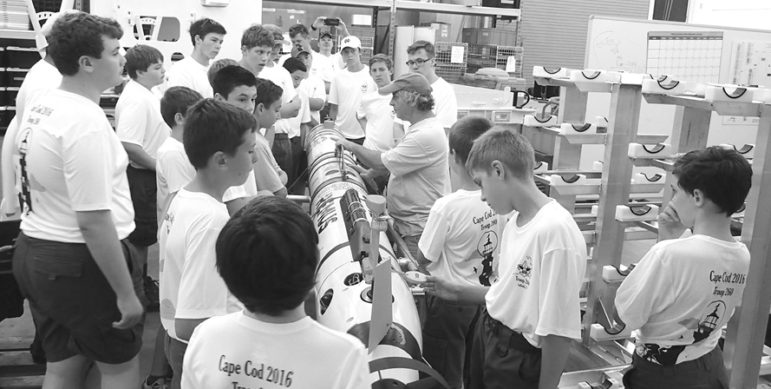 Boy Scout Troop 260 bicycled the Cape Cod Trail system in August and received a behind-the-scenes tour of Woods Hole Oceanographic Institute. Here they are learning about a REMUS robot from Senior Engineer Paul “Luigi” Fucile.