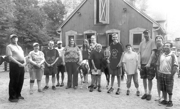 The Bowling Buddies group is pictured at the On-Target Mini-Horse Farm during one of their visits this summer. Two of the little horses may be seen near the middle of the photo.