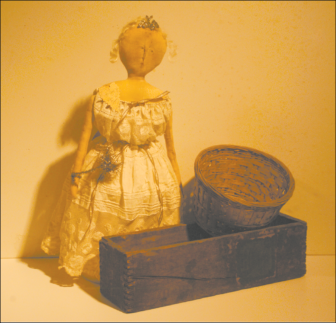 Among the items to be on view in the Holidayfest exhibit at the King House Museum are this box labeled for Five 70¢ Plugs of P. Lorillard tobacco; an interesting, small basket; and an old doll whose gown conceals a round box, perhaps for sewing supplies. Holidayfest will take place on December 3 and 4; the public is invited.