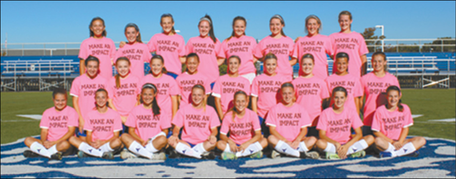 The SHS Girls Soccer team is pictured on Beneski Field wearing their “MAKE AN IMPACT” pink t-shirts in support of the March of Dimes.