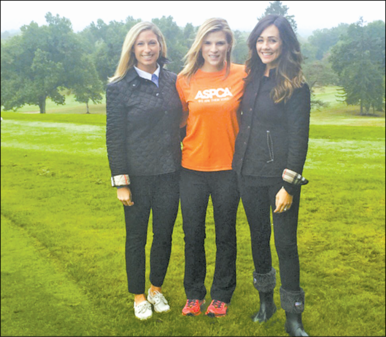 Michaela (Seccareccia) Johnson, left, and Alana Furnari, right, lend a helping hand to Kelly at the outing.