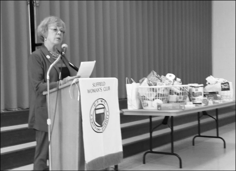 Lisa Miller, GFWC/CT Domestic Violence Chairperson, addresses the Suffield Woman’s Club at their October meeting. Beside Mrs. Miller is a table full of items donated for The Network Against Domestic Violence.