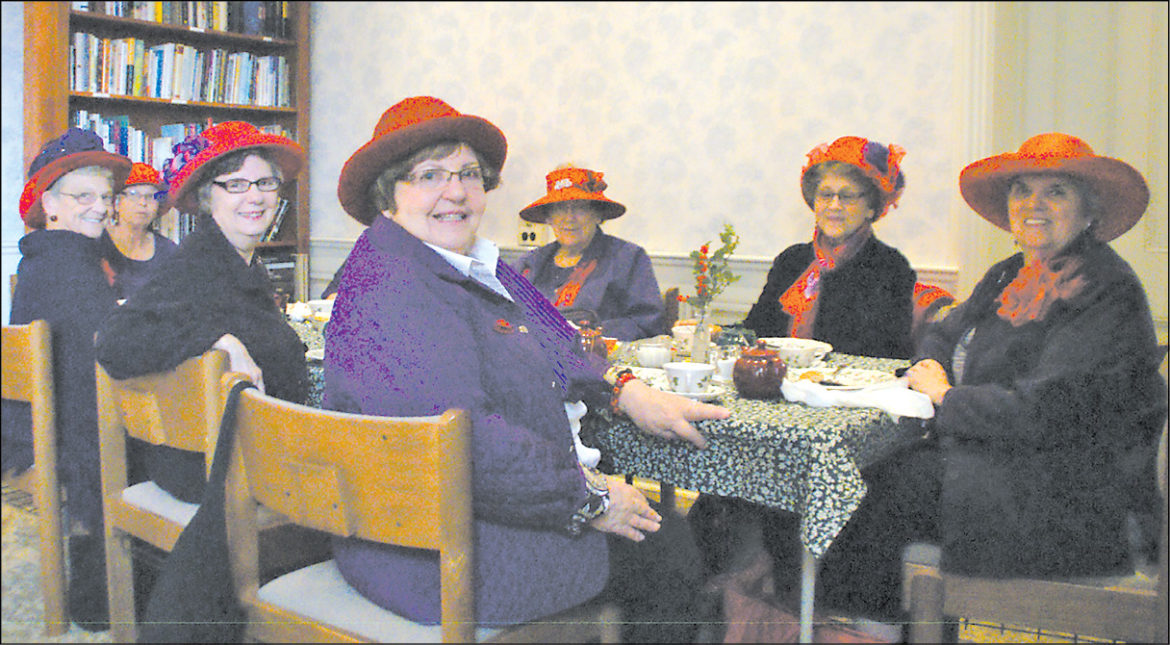 The Suffield Red Hat Society ladies are pictured at the Victorian Tea offered by the First Congregational Church during Christmas in Suffield. Presiding at the right is Carol Markwell. Downstairs, Fellowship Hall was packed with church sales tables and other vendors.
