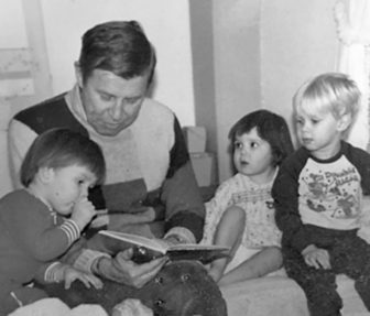Bob reads to his grandchildren, Robin Warren and Margo Warren and Andrew Johnson.