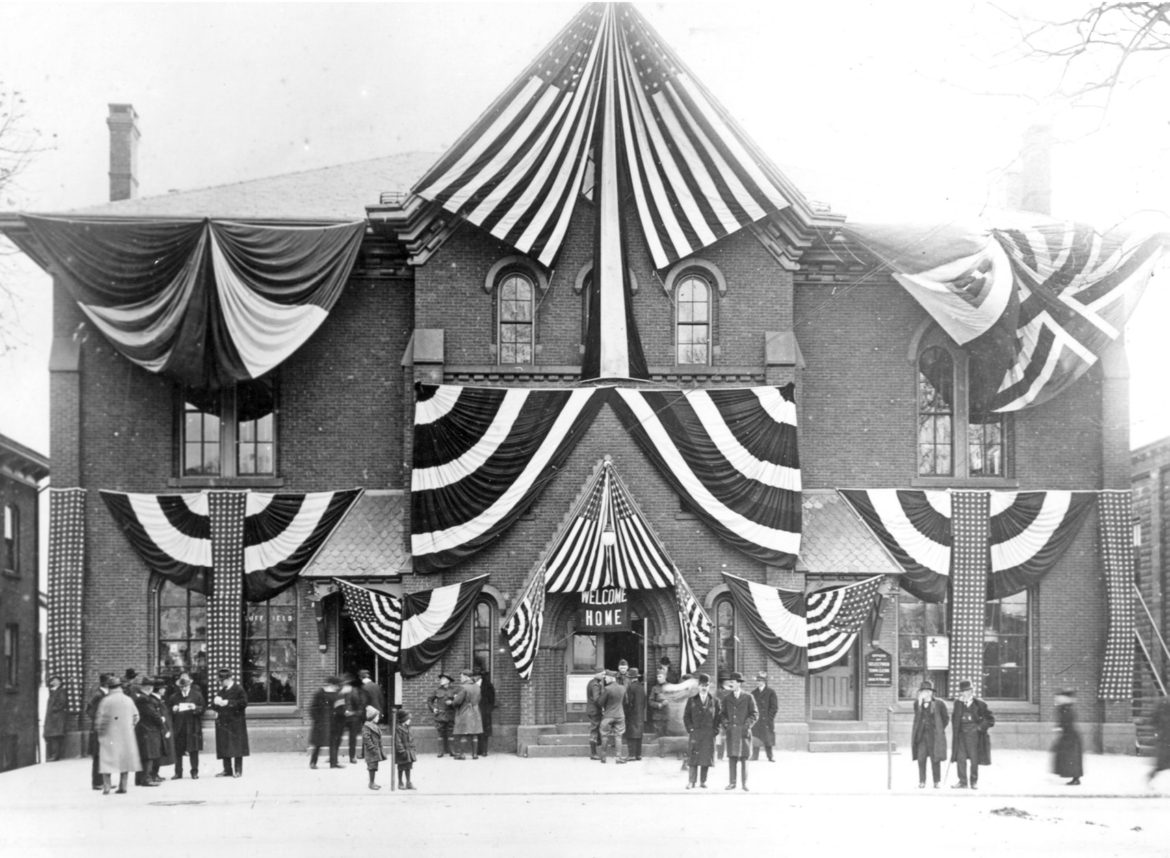 This “Welcome Home” picture of Suffield’s well-decorated old Town Hall was almost certainly taken in November 1919, when the town held a major celebration honoring the veterans of World War I, a year after the Armistice. The old Town Hall, demolished in 1970, was located on Main Street, where the library building is now.