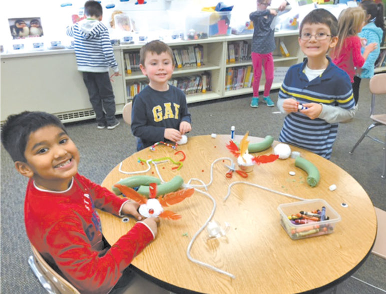 Spaulding School first grade students (clockwise) Ryan Dave, Ethan Cromack and Jacob Carreira remain engaged and collaborative during a makerspace project in the library media center.