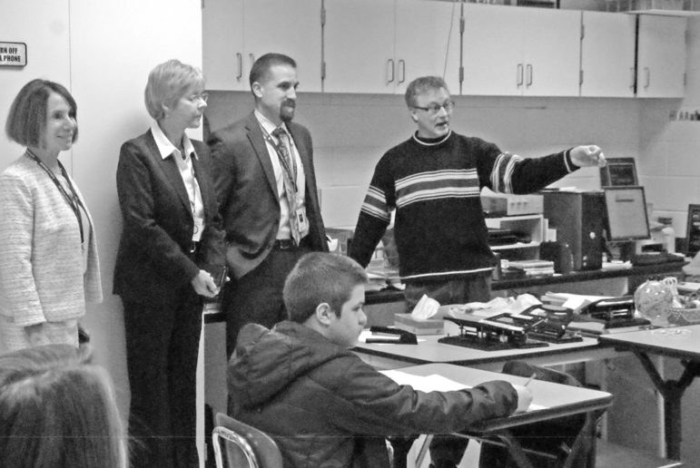State Representative Tami Zawistowski, second from left, listens as teacher Carl Casinghino explains what he is doing in his Suffield High School video production class. From the left: Superintendent of Schools Karen Berasi, Zawistowski, Principal Steve Moccio, Casinghino. Representative Zawistowsk had been invited to see some examples of what goes on at the school.