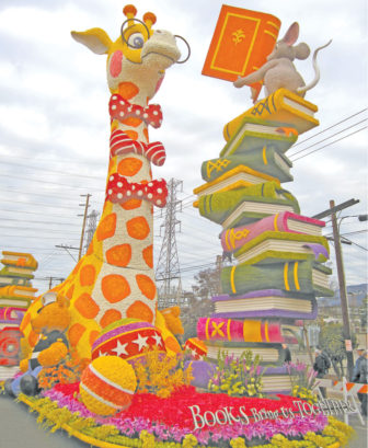The UPS float for the Rose Bowl Parade, "Books Bring us TOGETHER," features Geoffrey the Toys "R" Us giraffe.