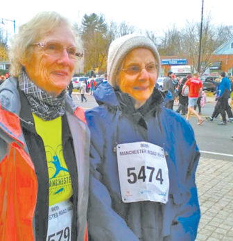 Two local enthusiasts, Joan Bedard, left, and Sarah Segar, are pictured at the Thanksgiving Day Manchester Road Race on November 24, where they finished first and second in the female 85-89 division. Joan, the division winner, set the course record for the division last year. Sarah, second, aged out of the division two weeks after the race. This year, the 80th running of the 4.748-mile race, counted 11,226 registered runners and walkers finishing the course.