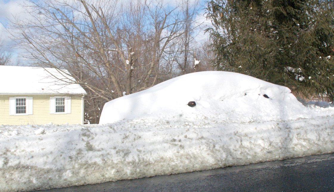Perhaps this car's owners were enjoying a sunny beach in Florida. But on the morning after the February 9 snowstorm, the car they left at home was almost entirely camouflaged in their front yard on the back side of West Suffield Mountain.