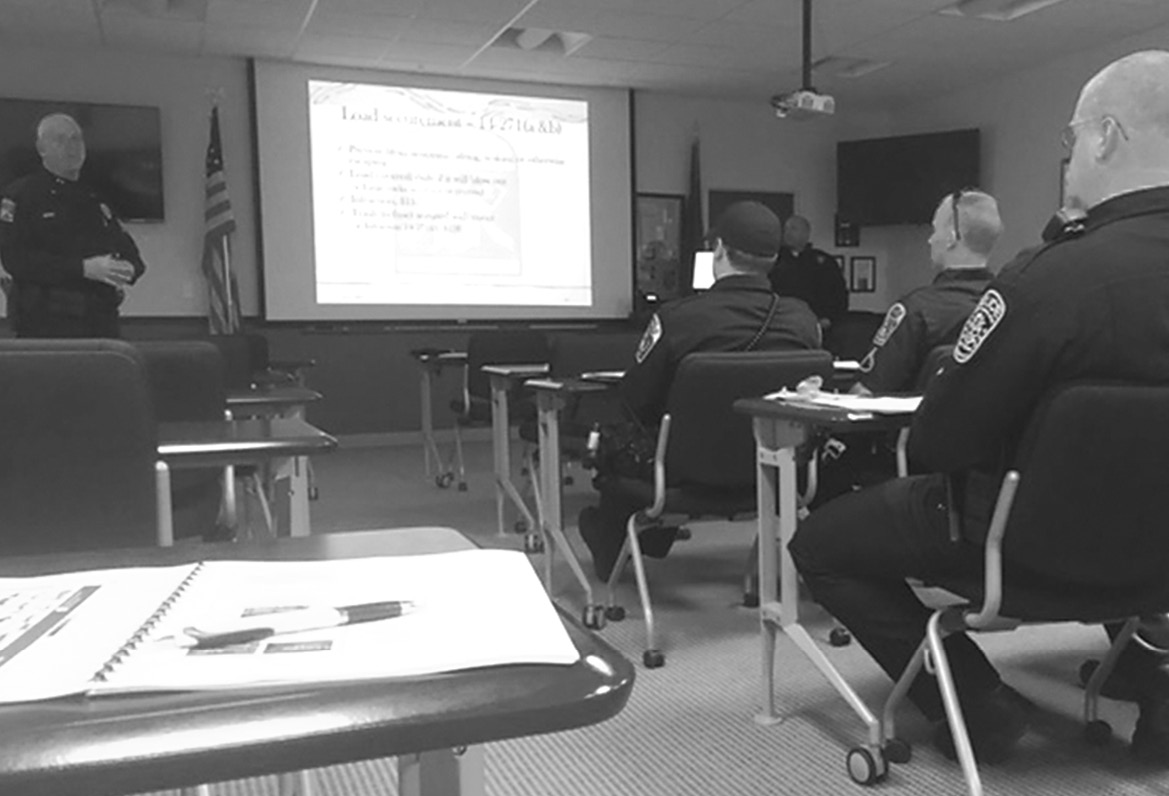 Officers from eight towns and the state listen as Lieut. Donald Bridge, Jr., of the Connecticut MVD, standing at front left, lectures in a Suffield-sponsored training day on commercial vehicle policing.