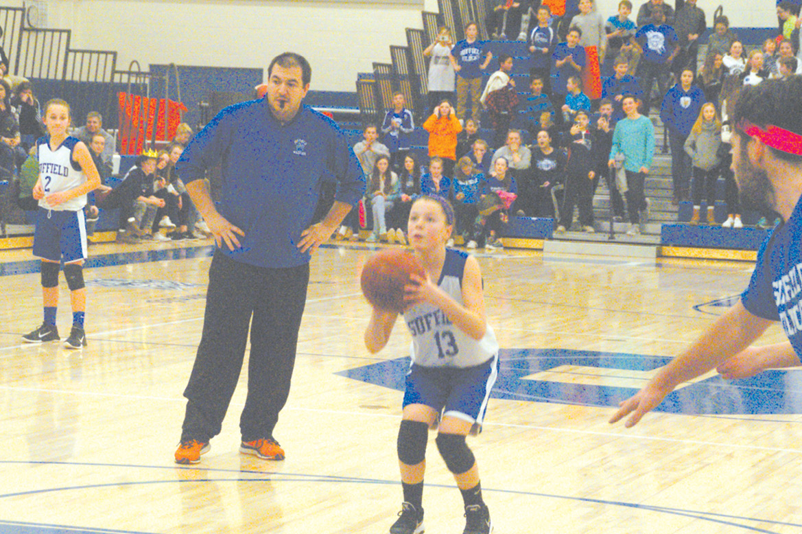 In the final seconds of the SMS student-faculty basketball game on March 10, Ellen Miller concentrates on a free throw that could have tied the match. No such luck! The students lost at 50-51.