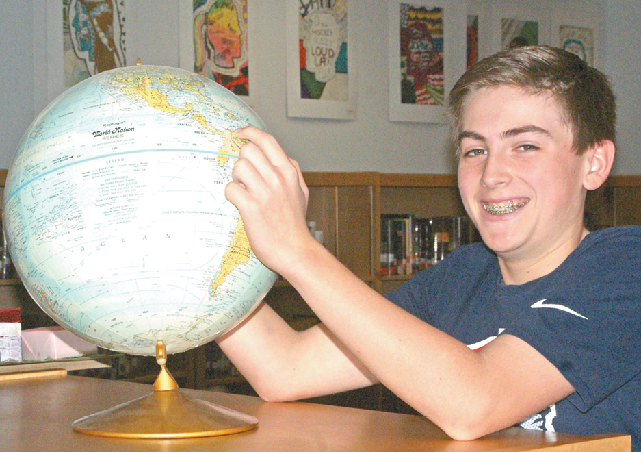In his school’s library, Nicholas Sickman points on the globe to the farthest from Suffield he has travelled.  A seventh grader at Suffield Middle School, Nick won the opportunity to represent Suffield in the Connecticut State Geography Bee, sponsored by National Geographic Magazine.  (His farthest spot is the family timeshare in Aruba, a small island near Venezuela.)