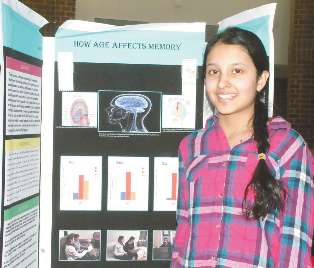Akshita Jindal, an eighth grader, is pictured at the display board for her Science Fair project, “How Age Affects Short-Term Memory.” She won Second Honors at the Connecticut Science Fair in March. Many of the Science Club members put their projects on display in the SHS rotunda on March 20, after the fair closed.