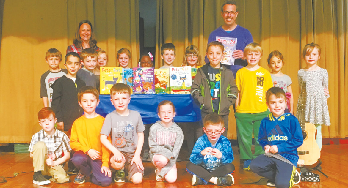 Pete the Cat author Eric Litwin, standing at right, poses with Christy Baril, left, and her first grade class after a Spaulding School assembly promoting literacy.