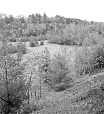 This view of the sand pit property, looking down from Lake Road, shows the previously excavated region where the relocated road will be routed.