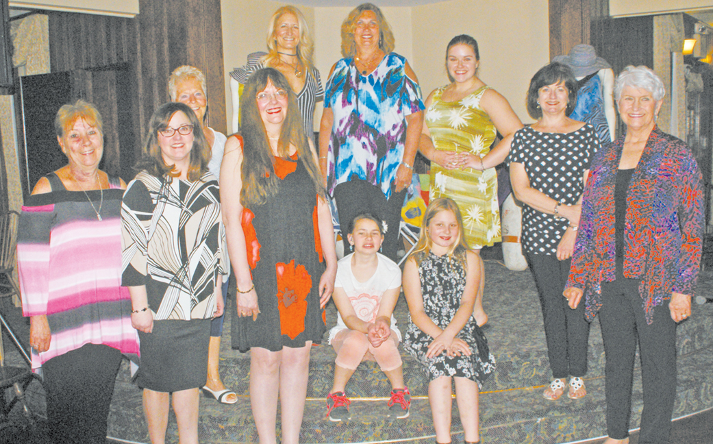 Yvonne Turgeon left, proprietor of the Little Black Dress shop in Enfield, is pictured with the ten models who had just shown some of her new fashions on April 27 at the Cove, next to North Pond at Lake Congamond in a CRC benefit envent.  Can you pick out the mother-and-daughter pair from a notable Suffield family?