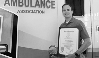 Ambulance Chief Art Groux is pictured alongside one of the SVAA ambulances with his new citiation certificate.