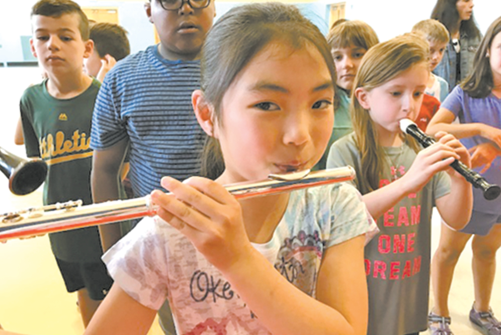 Second grade Spaulding student Maia Mignone enjoys playing the flute during the Instrument Zoo.