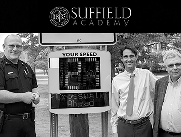 Men involved in an effort to calm vehicle speed in the town center pose next to the radar speed sign recently donated by Suffield Academy and installed by the Town.  From the left: SPD Chief Richard Brown, Academy Headmaster Charles Cahn III, Police Commission Chairman Kevin Armata.
