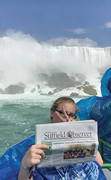 Alexis Wessling gives the peace sign as she cools off with the Observer on one of the Maid of the Mist boats at the base of Niagara Falls.