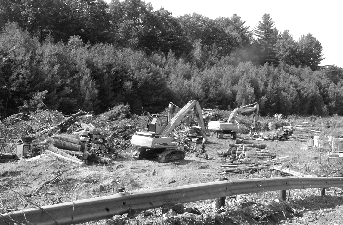 Big machines are shown at work in mid-September in the Lake Road sand pit. They are processing the remains of the trees removed from alongside the initial stretch of the road. This site preparation was being done for new owner Crestview by Moosehead Harvesting, whose local headquarters are on Austin Street.