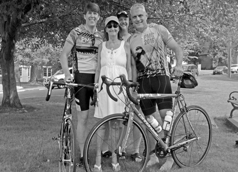Two riders prepare to set out from Suffield on August 4, a day early for the PMC Challenge; they’re pictured with two old friends.  The riders are Patrick McMahon, left, who rode only as far as Sturbridge, Mass., the official PMC start, and Chris Nikolis.  Between them are cancer survivor Suzanne Slovic from Rocky Hill, who rides partway each year when she can, and Chick Steedman from Pasadena, Calif., who has completed the whole challenge with Chris in previous years.  Another Suffield rider who completed this year’s challenge along with Chris, but didn’t start from Suffield, is John Gracey.