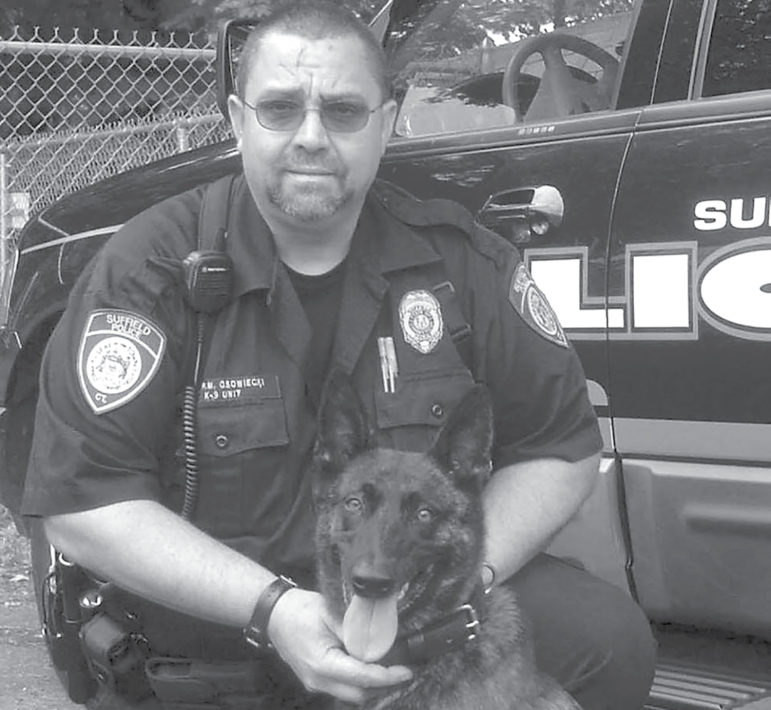 Officer Peter Osowiecki and his beloved friend, K9 "Z", are pictured next to his dog-adapted police car.