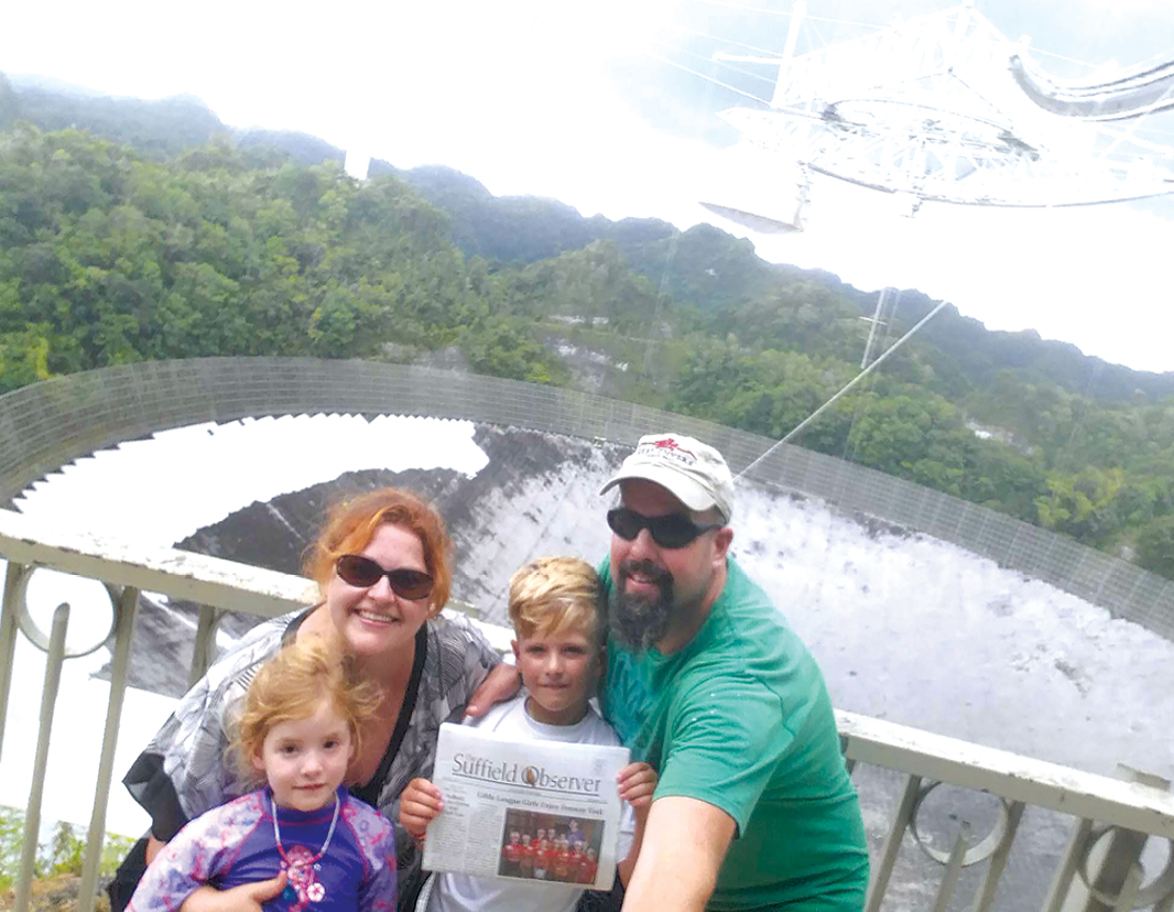 Megan and Kevin McCormick are pictured with their children Molly and Liam and the Observer alongside the giant radio telescope at the Arecibo Observatory in Puerto Rico on September 17 just a few days before hurricane Maria hit. They survived the life-changing adventure and made it home safely on the 24th.  The telescope, famous for its role in searching the extra-terrestrial intelligence, was badly damaged, perhaps destroyed.