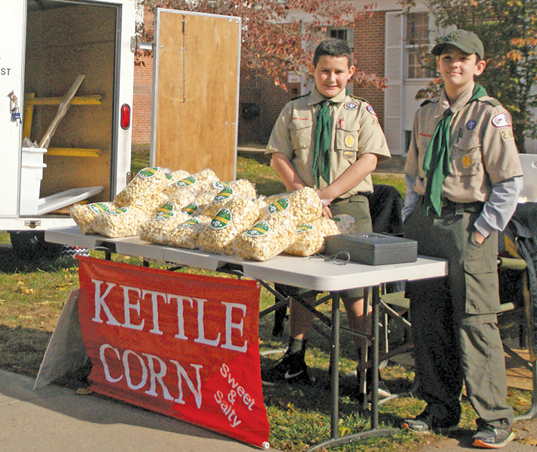 Troop 260 Scouts offer their famously delicious Kettle Corn, freshly popped on the spot, for Christmas in Suffield at Second Baptist Church, their sponsor. From the left: Daniel Craig and Bryce Klaus. Inside were a wide variety of crafts, baked goods, and attic treasures.