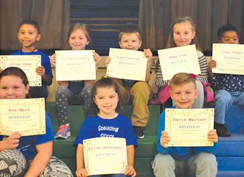 Spaulding students display their kindness certificates at a recent assembly focusing on that quality.
