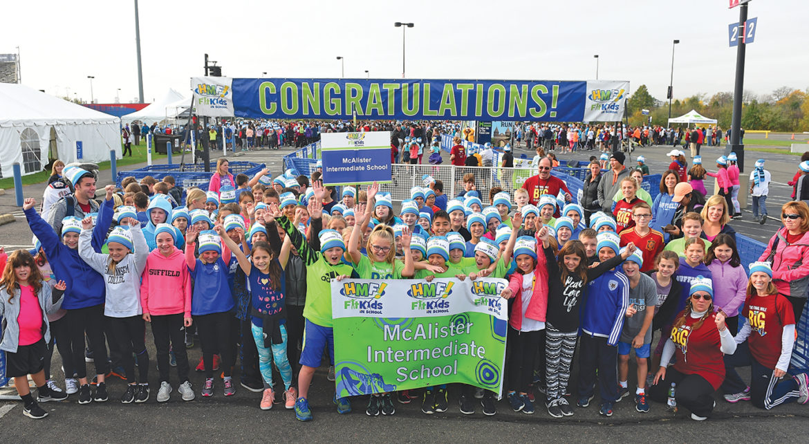 Gathered for their portrait on the parking lot at Rentschler Field are the kids from grades 4 and 5 at McAlister who topped off a five-week special fitness program there on November 2.