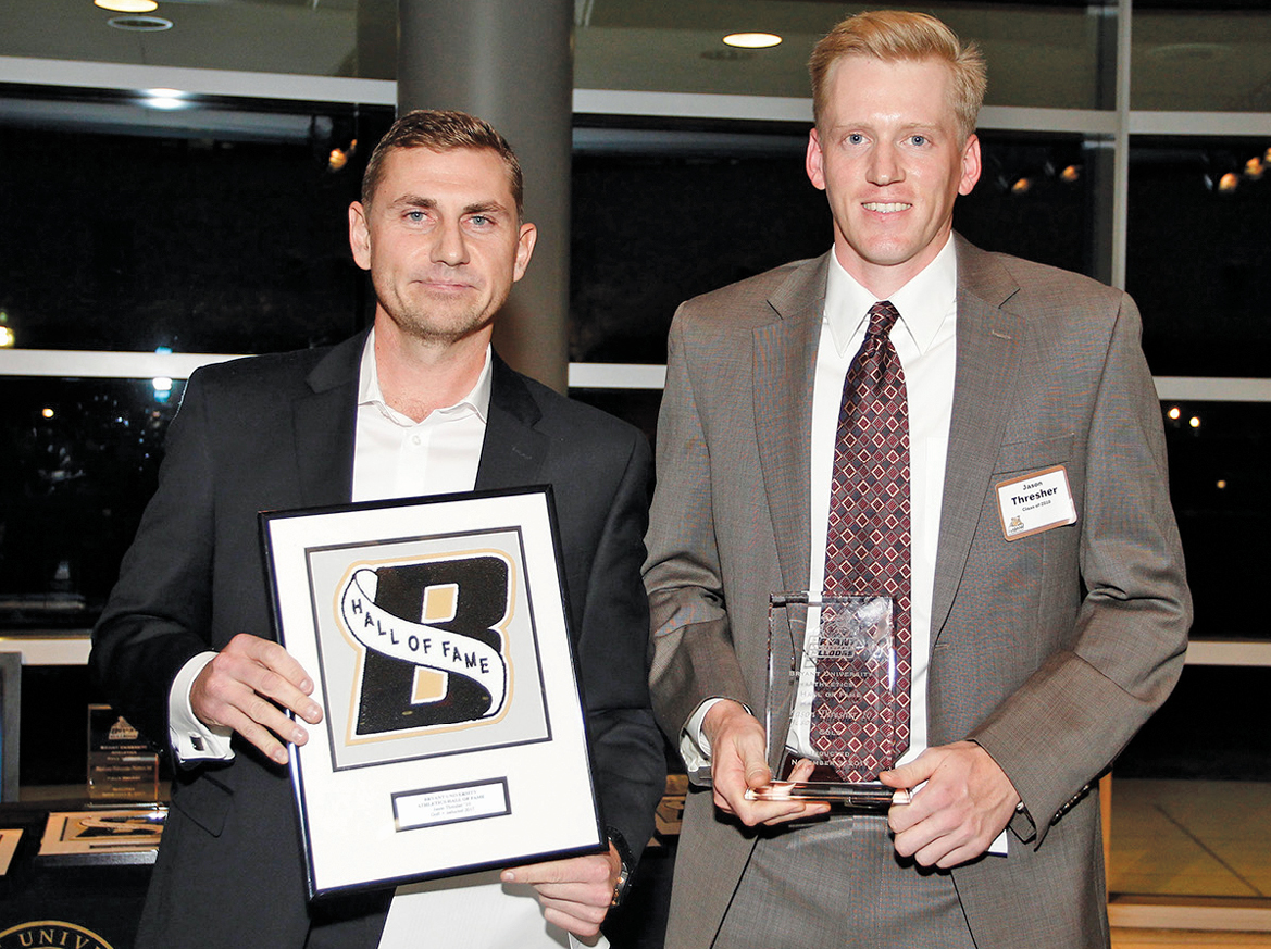 Suffield resident Jason Thresher, right, is pictured at the Bryant University ceremony on November 3 when he was inducted into the school’s Athletic Hall of Fame.