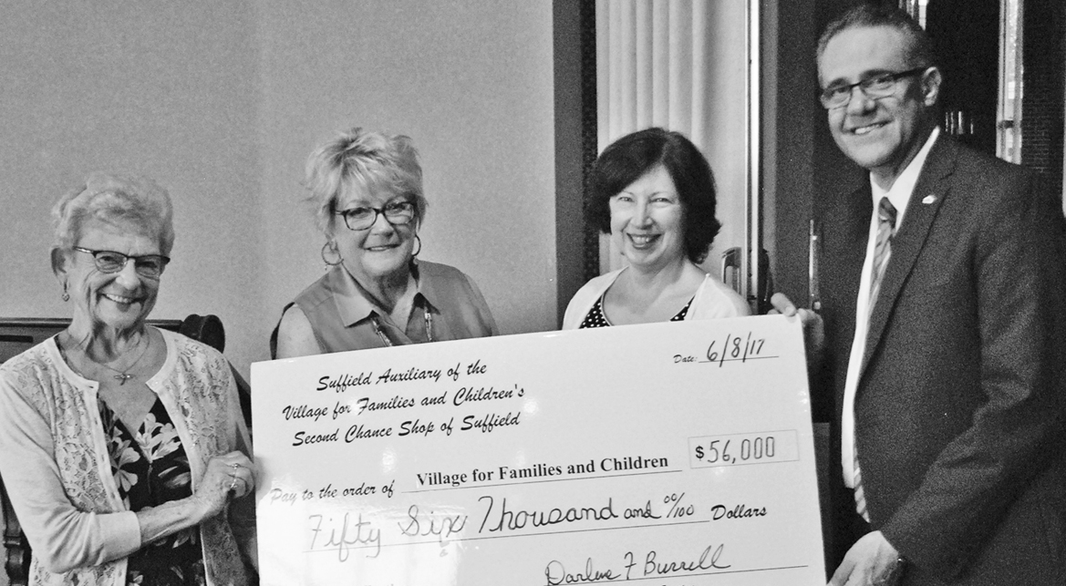 Leaders of the Suffield Auxiliary of The Village for Families & Children hand a $56,000 check to support The Village.  From the left: Auxiliary Co-presidents Sharen Lingenfelter and Lee Galluccio, Vice President Donna Jolly and President/CEO Galo Rodriguez of The Village.