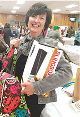 Renée Wood leaves with her winnings from a Designer Purse Bingo.