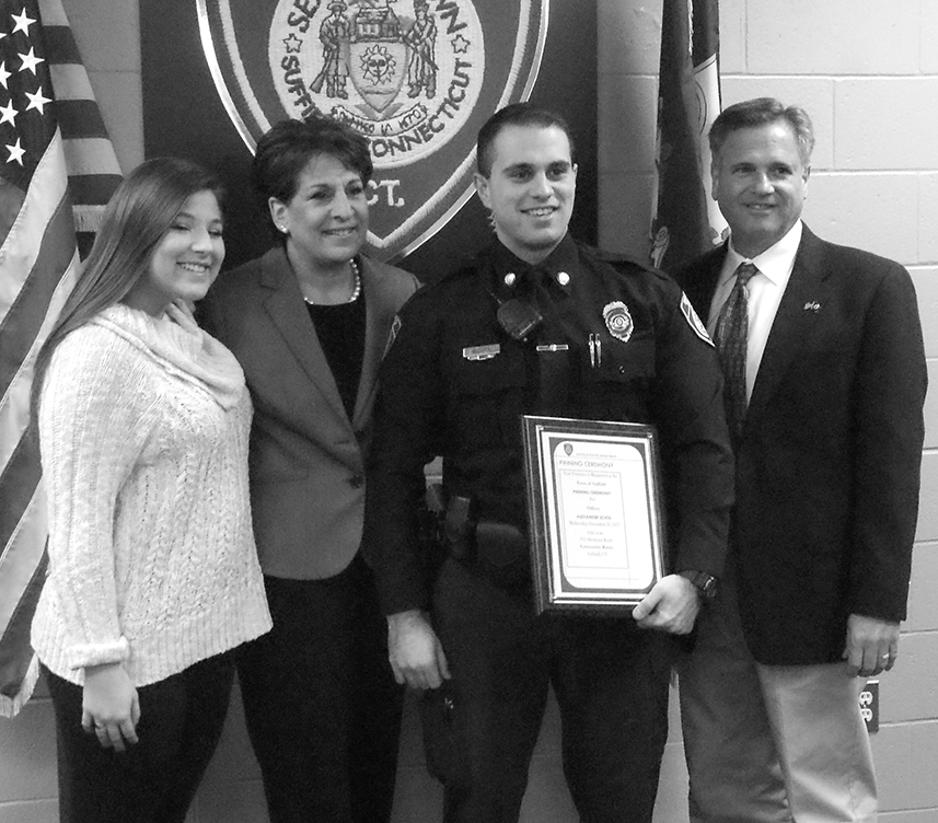 The new badge is a bit awry, but the smile is even and confident as new Suffield officer Alex Scata poses with his family after the department’s pinning ceremony. With him are, left and right: his sister Victoria, his mother Wendi, and his father Robert.