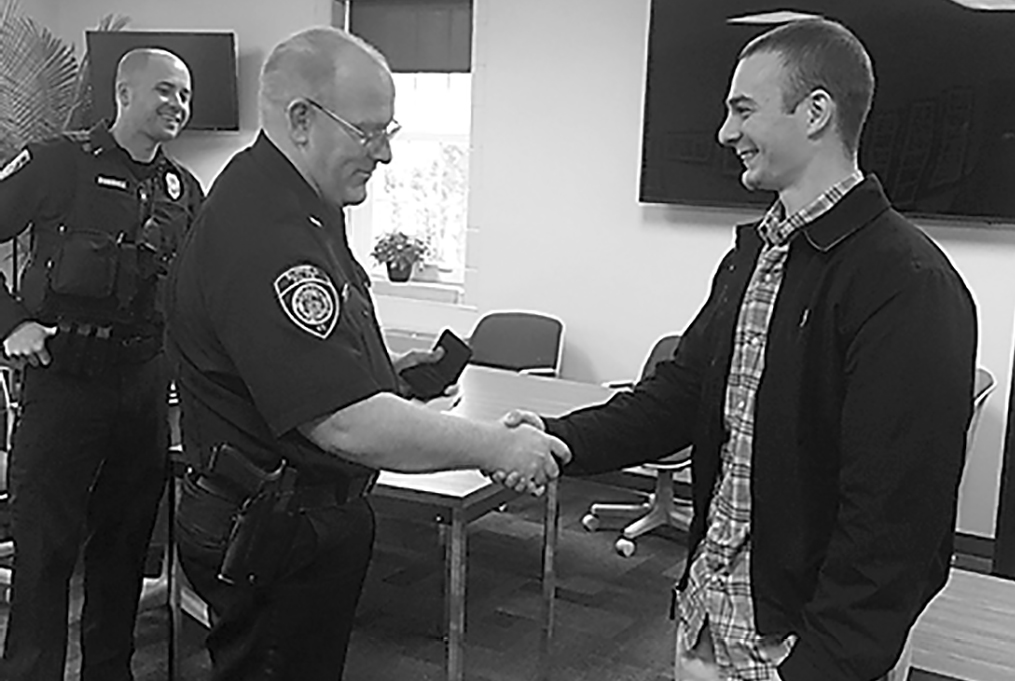 Chief Brown commends the police department’s departing intern, Nate Marshall, before presenting him with a Suffield Police Challenge Coin.