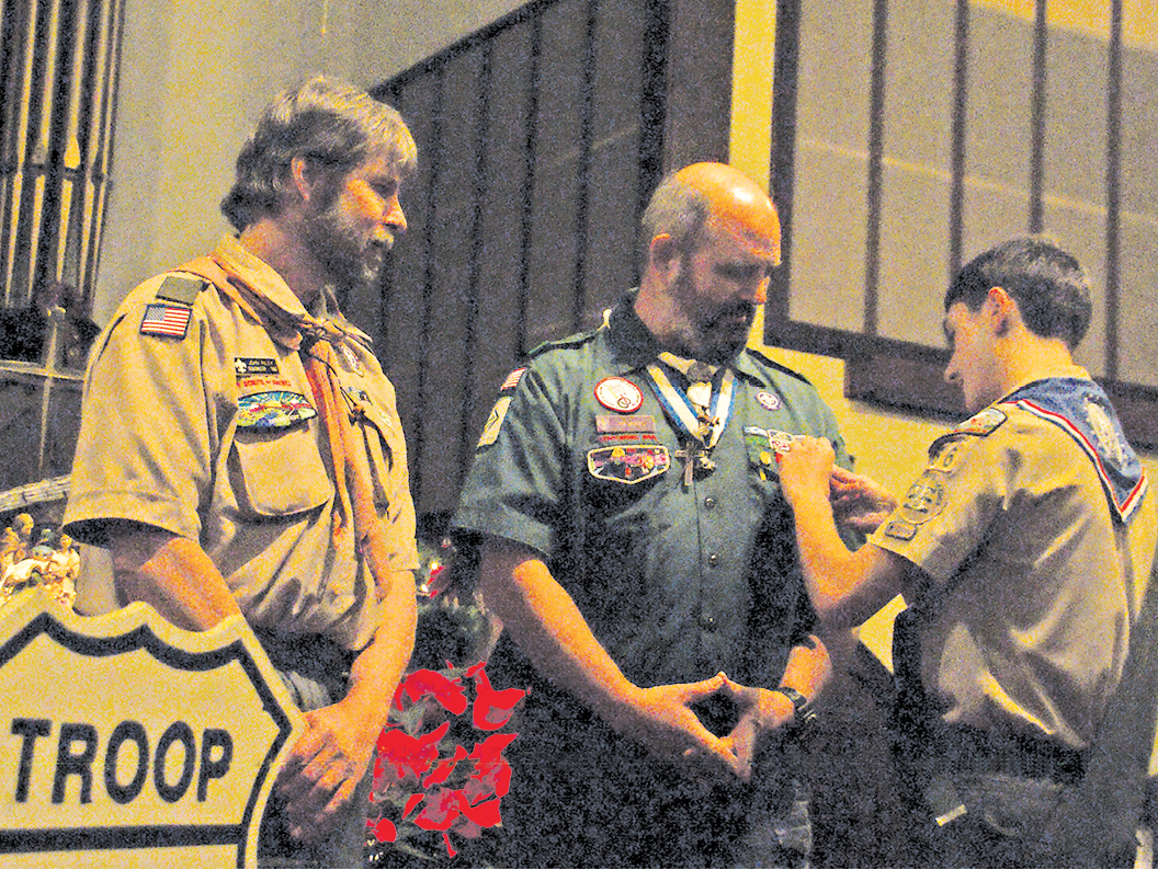 Troop 66’s new Eagle Scout Ben Bazzanno gives a Mentor Pin to former troop leader Jim Works. He gave another to Scoutmaster John Riley, left, crediting both with having been great help in his advancement though the Scout program.