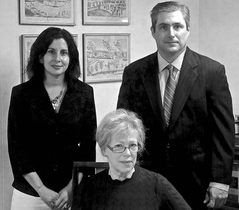 In this portrait of a newly-expanded partnership are, clockwise from the center: Vicky Spellman, Elizabeth Fanous, and David Kelly.