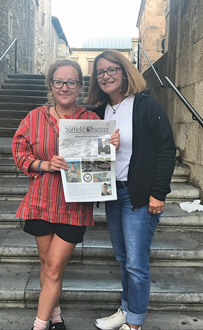 Nikki Benoit, left, took this special edition of The Suffield Observer honoring Dustin Doyon to share with Samantha Cordiliko in Spain. They’re pictured on a long stairway in Leon, the halfway point of the Camino De Santiago, a long pilgrimage across northern Spain.