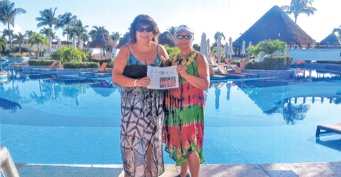 Pictured among the lounge chairs by the edge of a giant pool at the Moon Palace, a major resort in Cancun, Mexico, are Gerri Moodie, left and Chris Anderson. They took the Observer there in October, but had little occasion to read while they enjoyed their time at the pool and visited ancient Mayan pyramids.